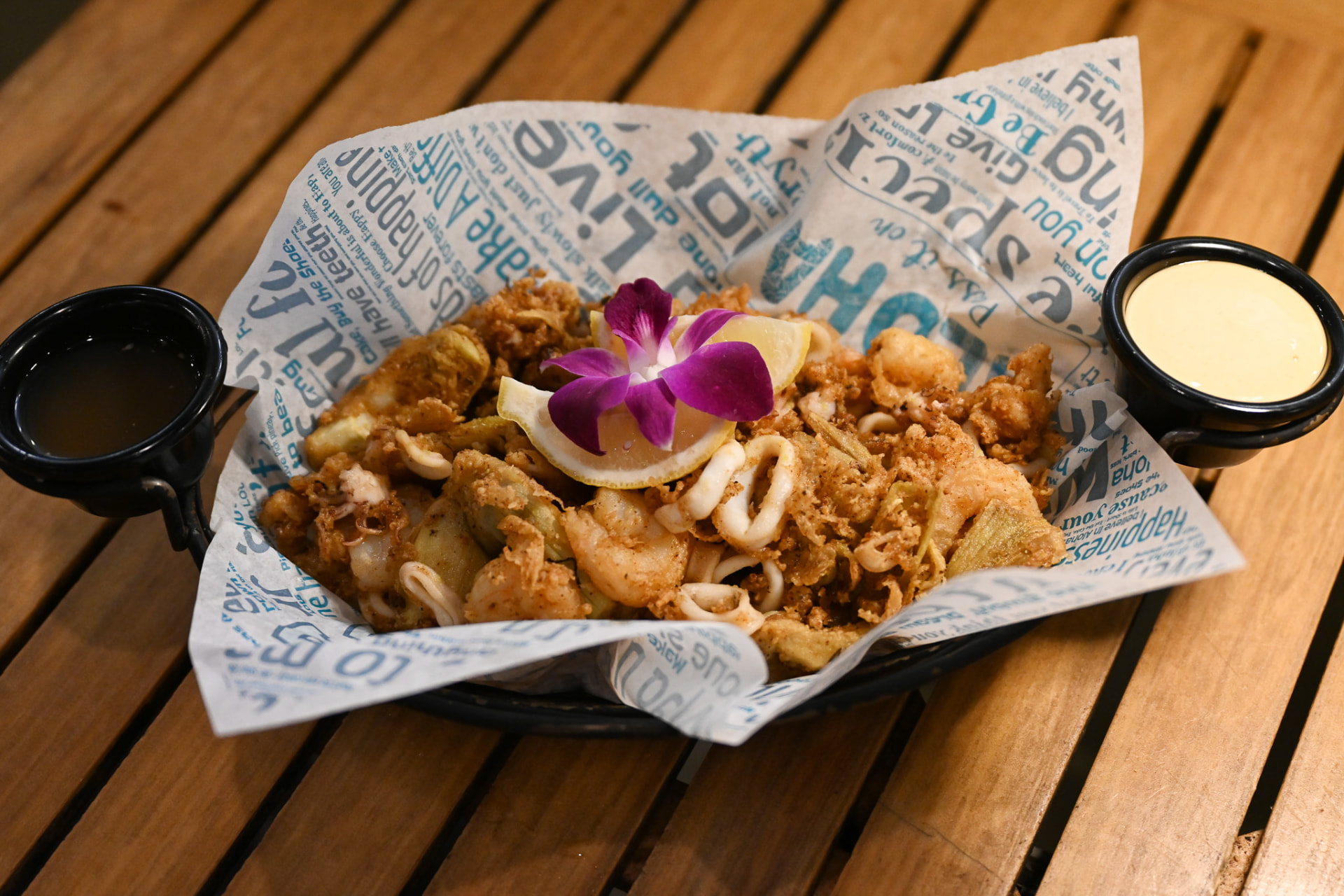Crispy calamari and shrimp basket with lemon, orchid and two dipping sauces