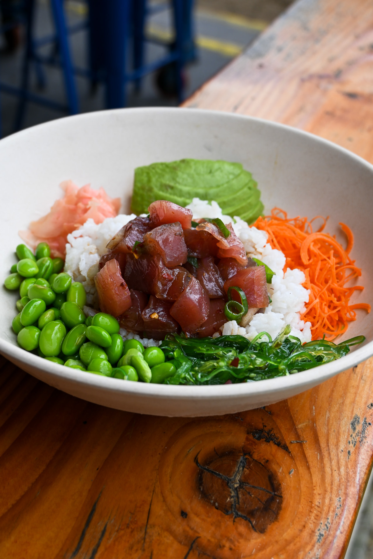 Ahi poke bowl over rice with edamame, avocado, carrot and ogo seaweed