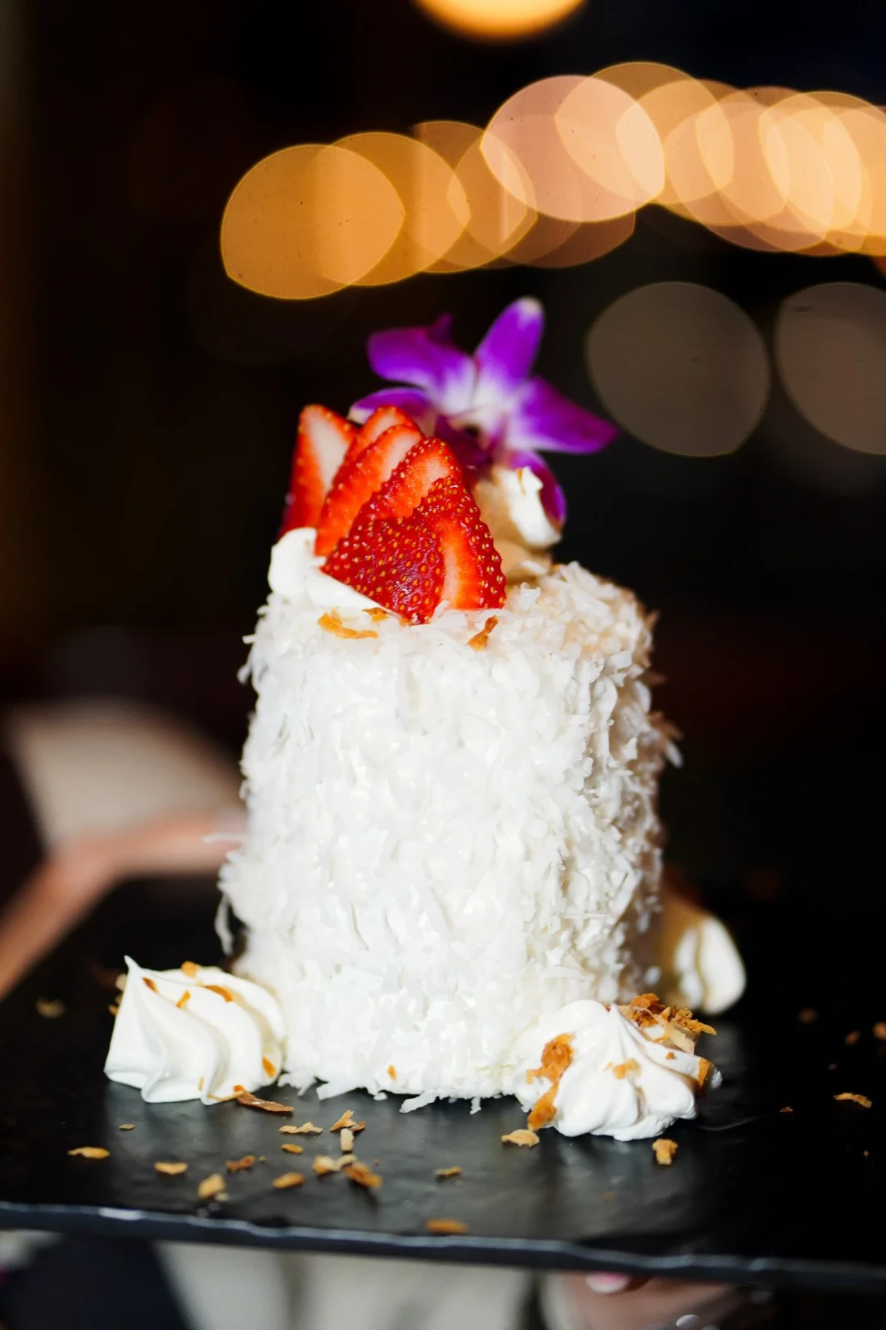 Coconut cake with fresh strawberries and whipped cream